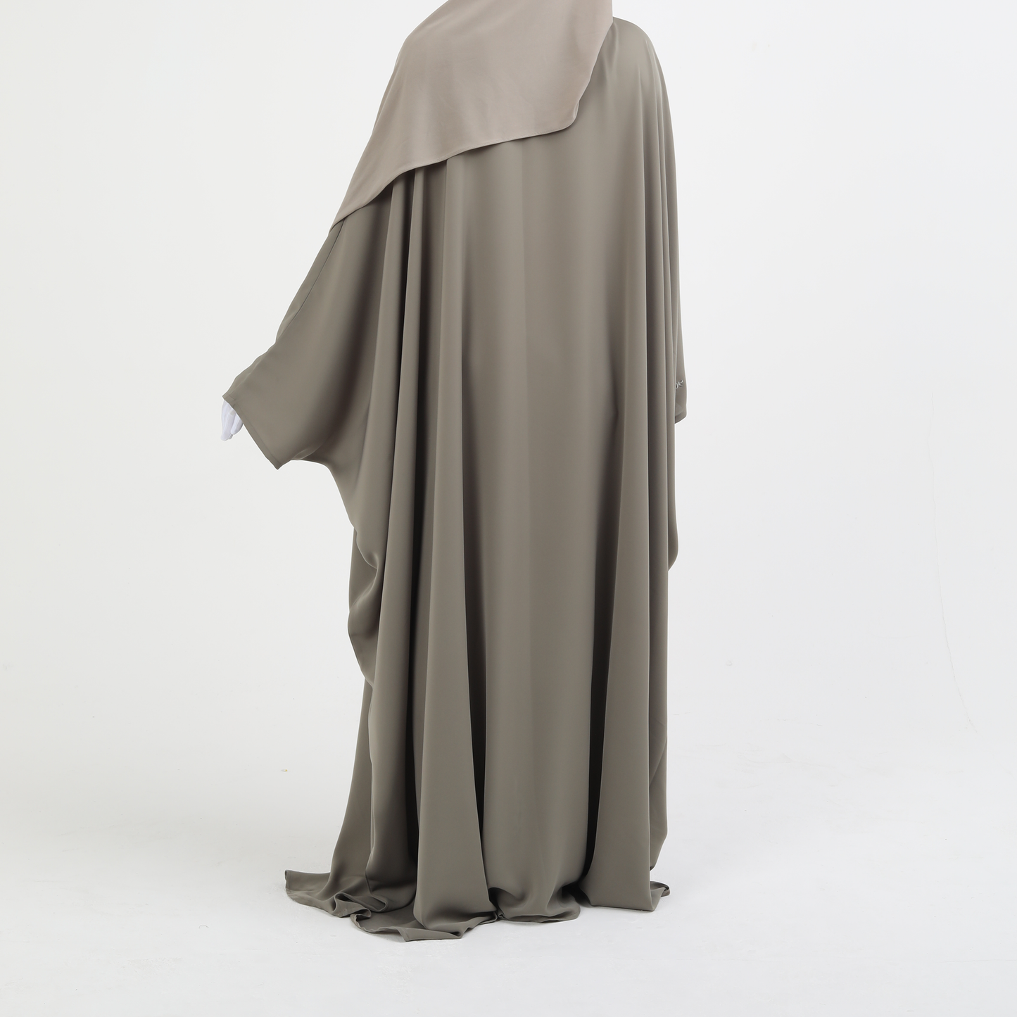 Long, flowing butterfly abaya in a neutral color on a white background