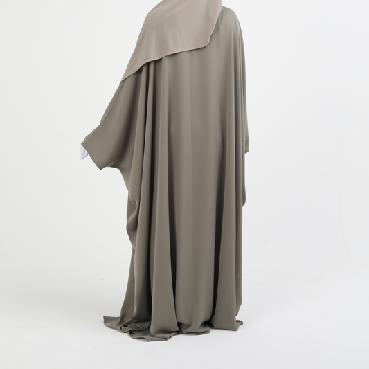 Long, flowing butterfly abaya in a neutral color on a white background